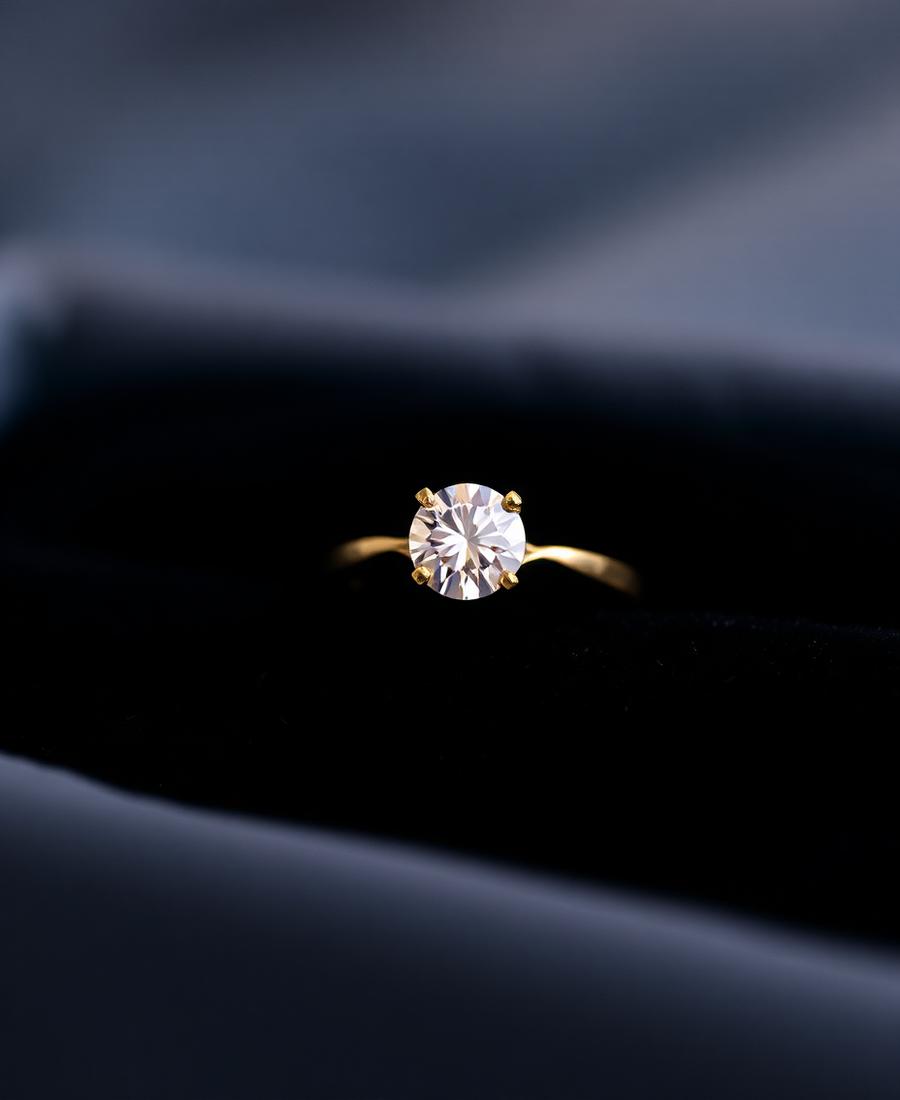 Gold solitaire diamond engagement ring in a dark velvet box